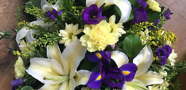 White and purple funeral flower spray