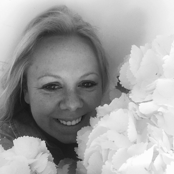 Lucie Mason of Lucie Mason Flowers with a huge bunch of beautiful white flowers
